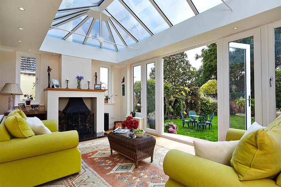 Living room orangery extension with large roof lantern finished in white UPVC with French doors and casement windows