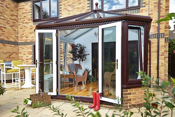 Victorian UPVC conservatory finished in dual dark woodgrain and white with tilt and turn windows from the Anglian conservatory range