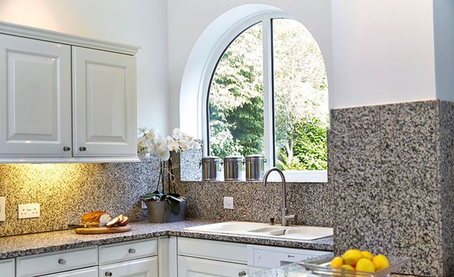 Shaped White UPVC casement window in modern kitchen from the Anglian shaped windows range