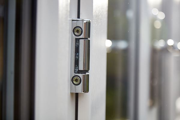 Close up of chrome door hinge on cream uPVC French doors from the Anglian doors range