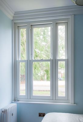 Narrow vertical sliding sash window finished in White UPVC in bedroom from the Anglian sash window range