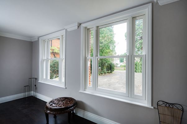 Pair of UPVC vertical sliding sash windows finished in White from the Anglian sliding sash window range