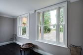 Pair of UPVC vertical sliding sash windows finished in White from the Anglian sliding sash window range
