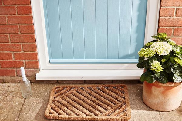 Close up of Duck Egg Blue composite front door and white door threshold from Anglian Home Improvements