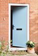 Duck Egg Blue composite front door in cottage style with black handle and letterbox brick house