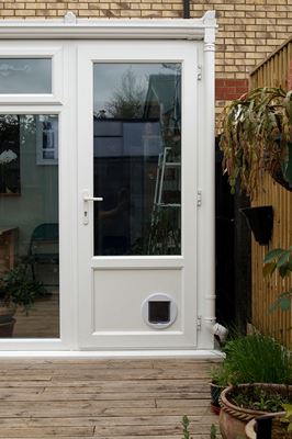 Half glazed UPVC conservatory back door finished in White with catflap from the Anglian uPVC range