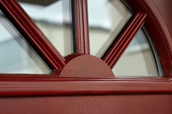 Close up of glass on wooden front door finished in Burgundy Red from the Anglian wooden front door range