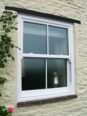 White uPVC sash window with Georgian style bars and obscure glass bottom from the Anglian sash window range