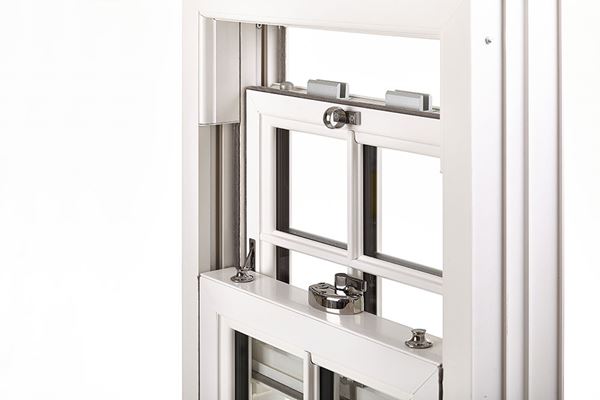 Close up of example white uPVC sash window and chrome window furniture from Anglian Home Improvements