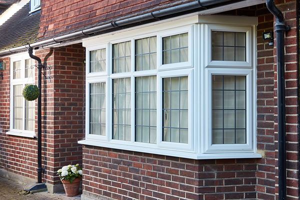 White UPVC bay window top hung casements with decorative leaded glass from the Anglian casement windows range