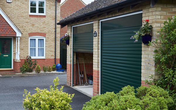 Pair of single fir green traditional aluminium roller garage doors side view from the Anglian roller door range