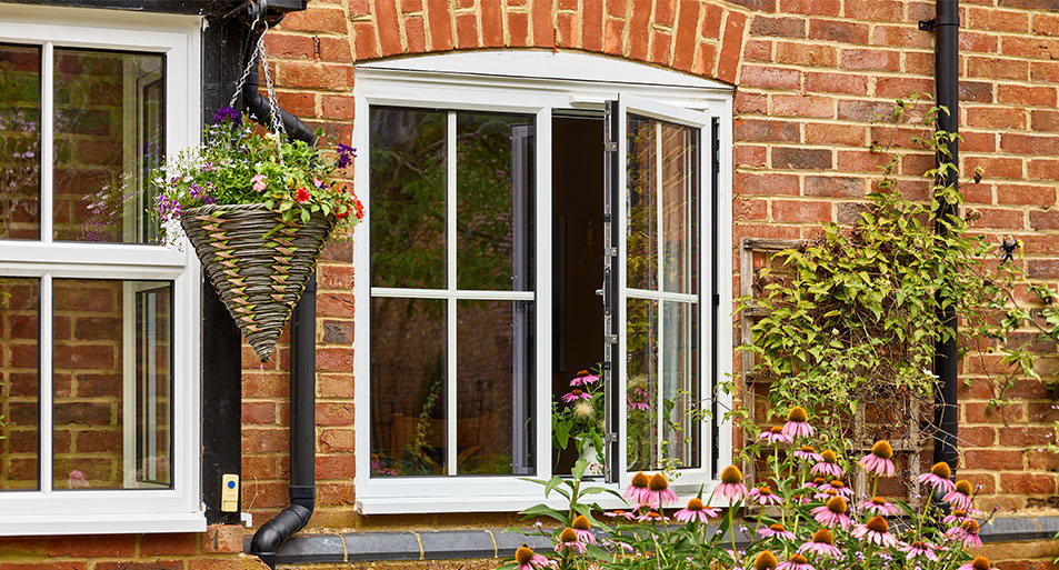 white casement window with Georgian bar inserts in open position