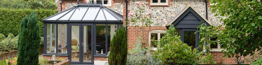 A stuning Elizabethan conservatory shown here in anthracite grey exterior with a classic white knight interior colour