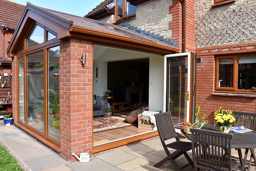 Regency extension with replica tile roof and dual golden brown bifold doors