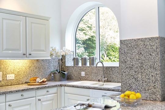 Decorative arch shaped kitchen window in White uPVC design inspiration from Anglian Home Improvements