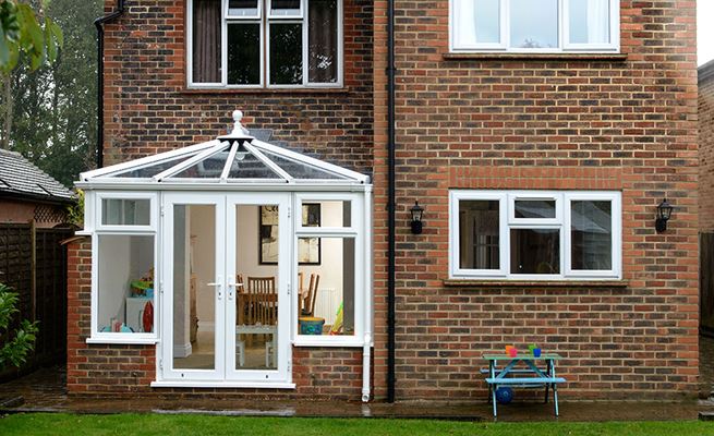 Small White UPVC Elizabethan conservatory with top hung casement windows and French doors from Anglian Home Improvements