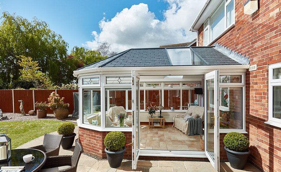 Tiled roof conservatory with glass panels from Anglian Home Improvements