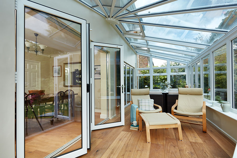 White aluminium bifold doors in harmony conservatory