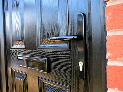 Black handle and letterbox on black composite front door Anglian Home Improvements