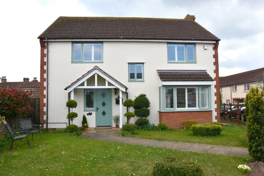 Sage green composite contemporary Lisbon door with sage green uPVC casement windows whole house