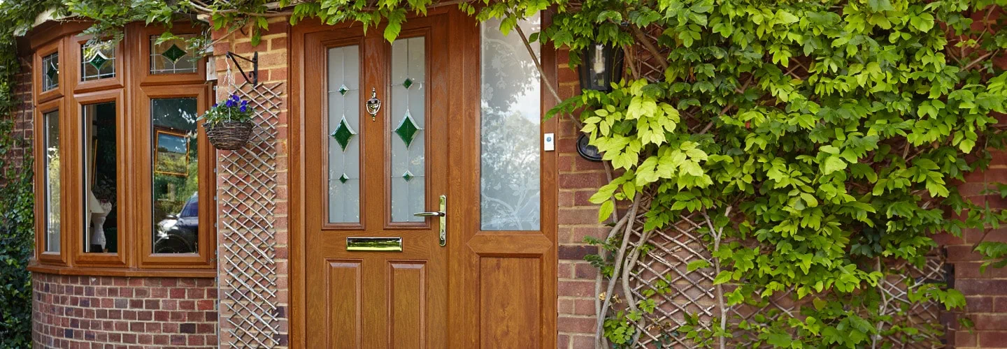 Golden oak bay windows and composite door with etched stained glass banner