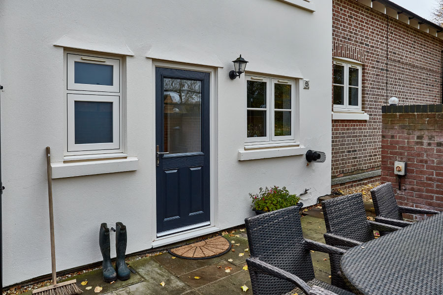 Anthracite grey composite door with cream flush casement windows