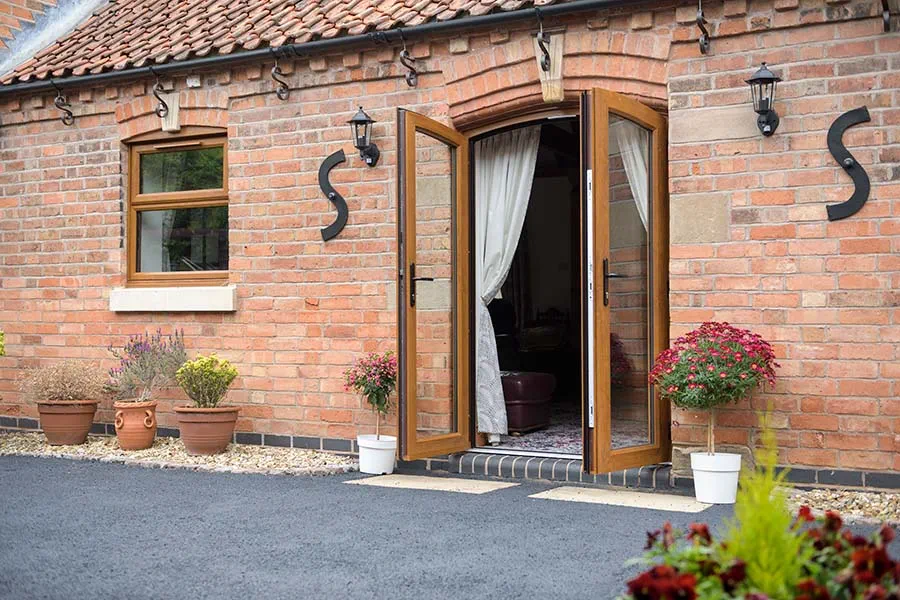 Golden oak PVCU French doors and Casement window