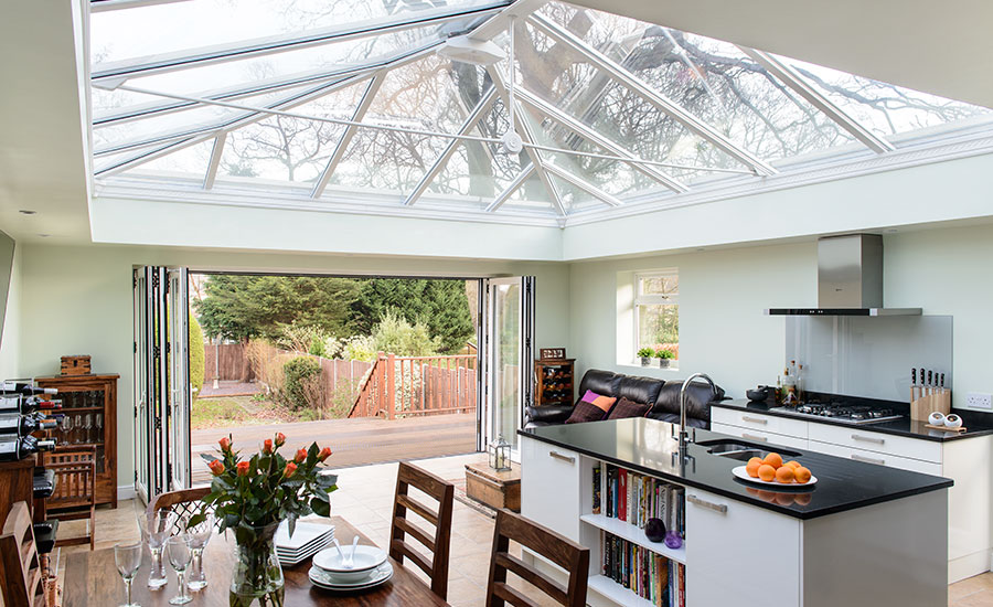Five panel White aluminium bi-fold doors opening from kitchen diner orangery onto garden from the Anglian bi-fold doors range