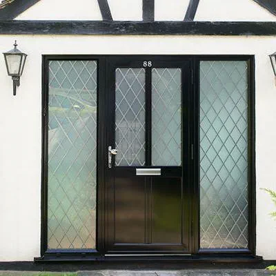Black aluminium traditional front door in Erlestoke design with leaded glass and side panels