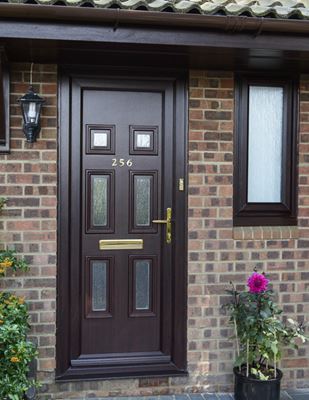 Dark woodgrain uPVC traditional front door with cotswold obscure glass from the Anglian front door range