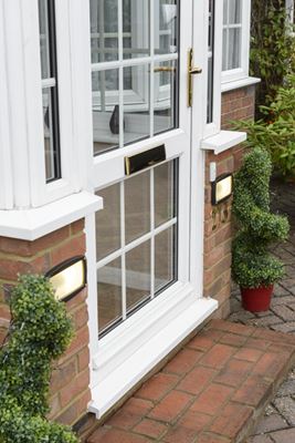 Side view of porch with White uPVC front door glazed with Georgian bars and gold door furniture from the Anglian porches range