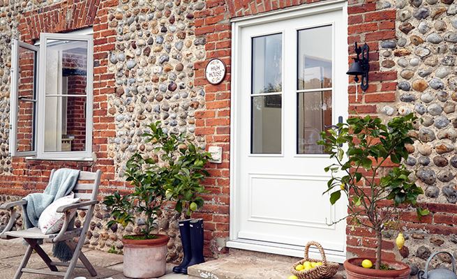 White wide wooden back door half glazed with cottage bars from the Anglian cottage wooden door range