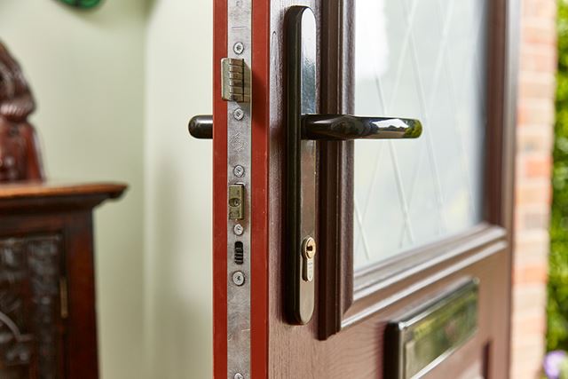 Dark woodgrain uPVC door close up lock