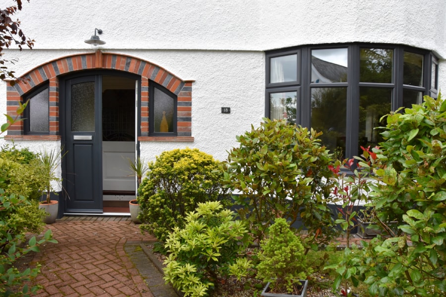 Front of home with wooden front door in Anthracite Grey