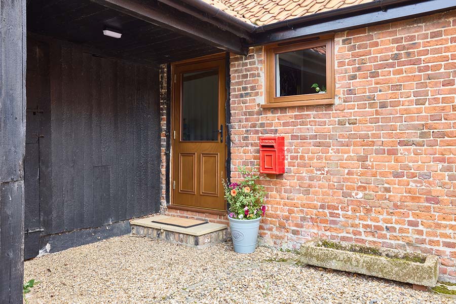 Golden oak wooden Shannon front door with matching window