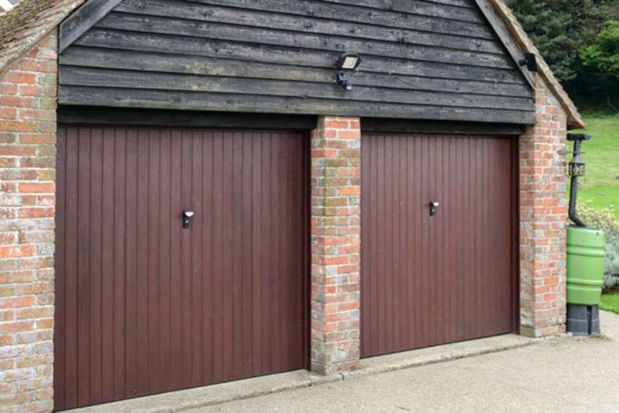 Double garage featuring dark woodgrain one piece GRP garage doors