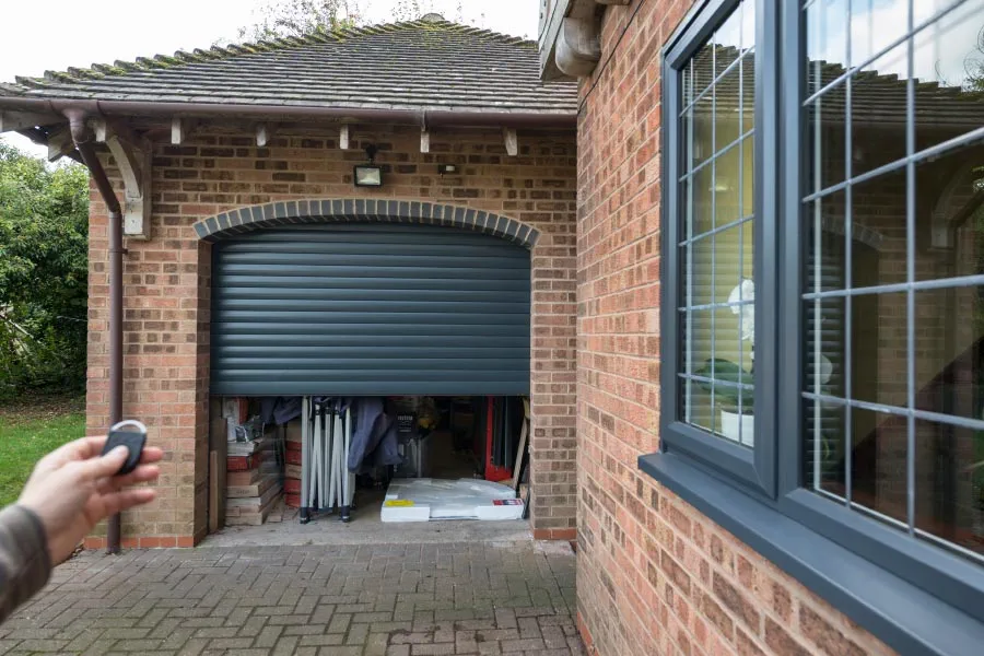 Half open modern electric aluminium roller garage door from Anglian Home Improvements
