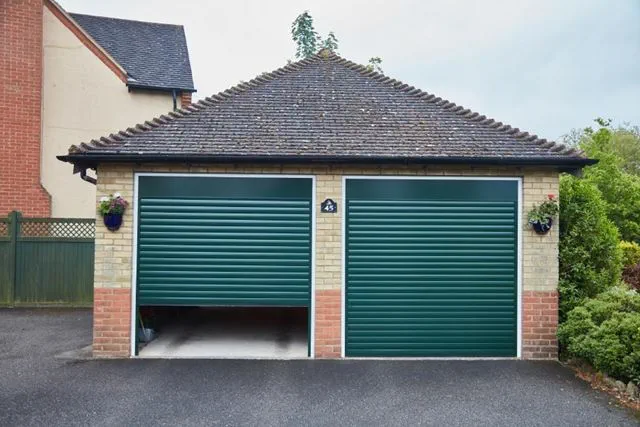 Pair of Fir Green single garage doors in aluminium roller style from Anglian Home Improvements