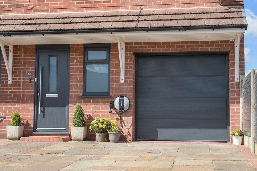 Anthracite grey steel sectional garage door and front door