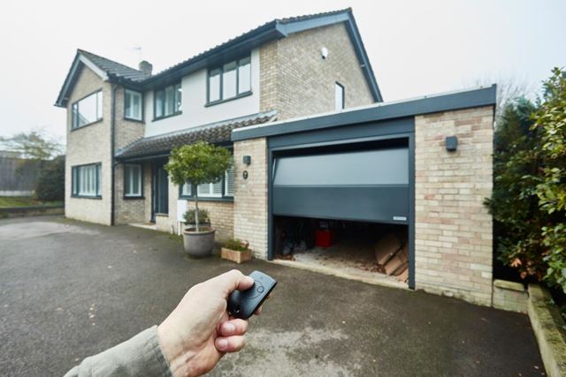 Remote opening electric steel sectional garage door in Anthracite Grey from the Anglian garage door range