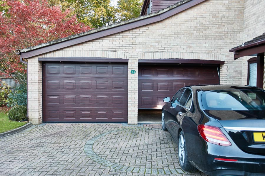 Pair of Dark Woodgrain steel sectional double garage door from Anglian sectional garage door range