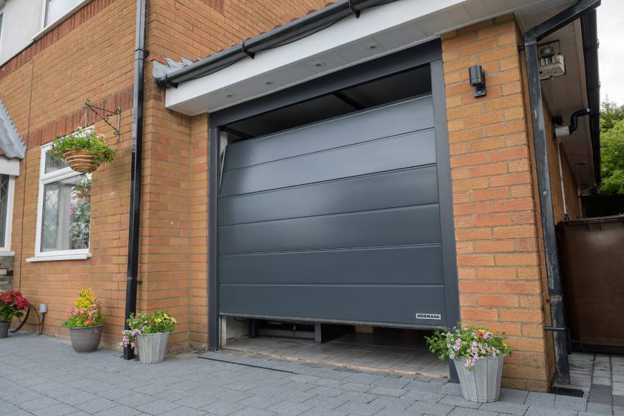 Steel section garage door in anthracite grey close up opening