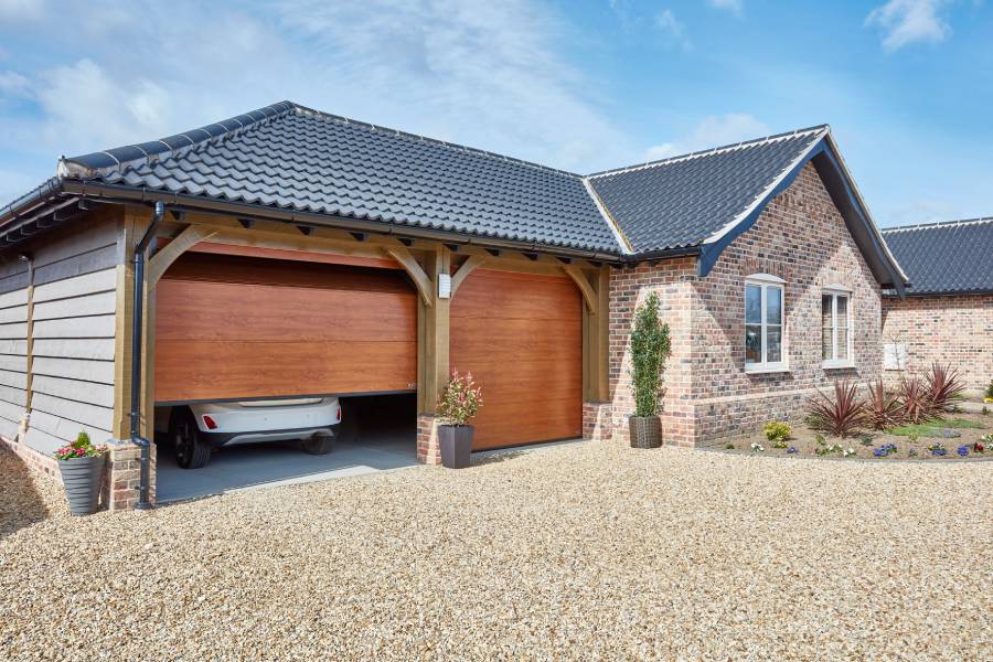 Steel sectional double garage door in golden oak