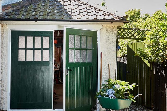 Fir green side hinge garage doors in open position