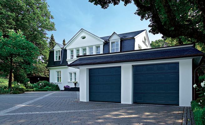Pair of Anthracite Grey steel sectional garage doors in Georgian style outside a large white traditional house