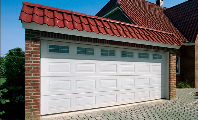 White Georgian style steel sectional garage door with glazed top panels from the Anglian sectional garage doors range