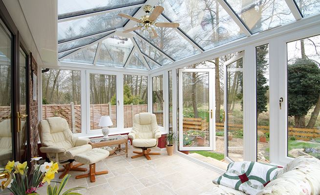 Dual White and Dark Woodgrain modern UPVC conservatory interior living space view from the Anglian Home Improvements conservatory range