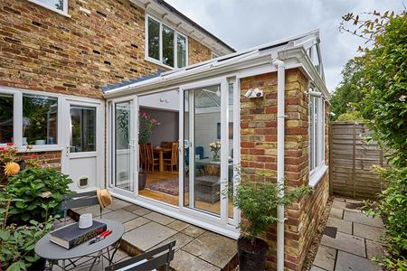 White uPVC Regency conservatory with sliding patio doors in open position