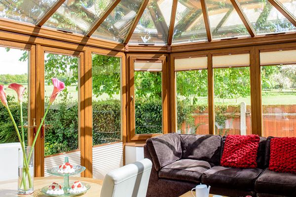Golden Oak Edwardian UPVC conservatory with French doors and conservatory blinds from the Anglian conservatory range