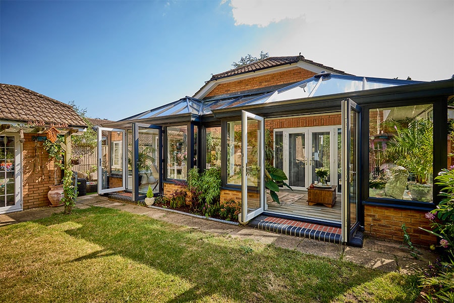 Dual Anthracite grey duo Elizabethan coservatories with french doors in open position